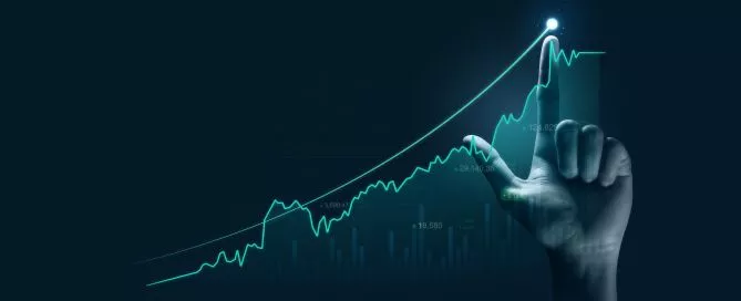 Mão humana com dedo apontando para um gráfico digital com um indicador crescente.