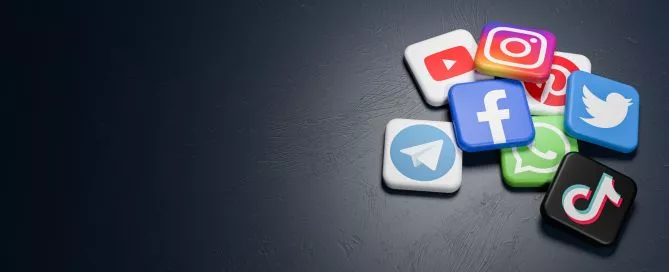 Botões com símbolos de redes sociais em uma superfície escura, simbolizando o Dark Social.